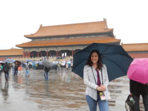 Dianne in the rain with an umbrella at the Forbidden City in China. 